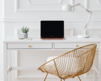 gold chair in front of desk with laptop