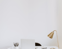 laptop and lamp sitting on desk