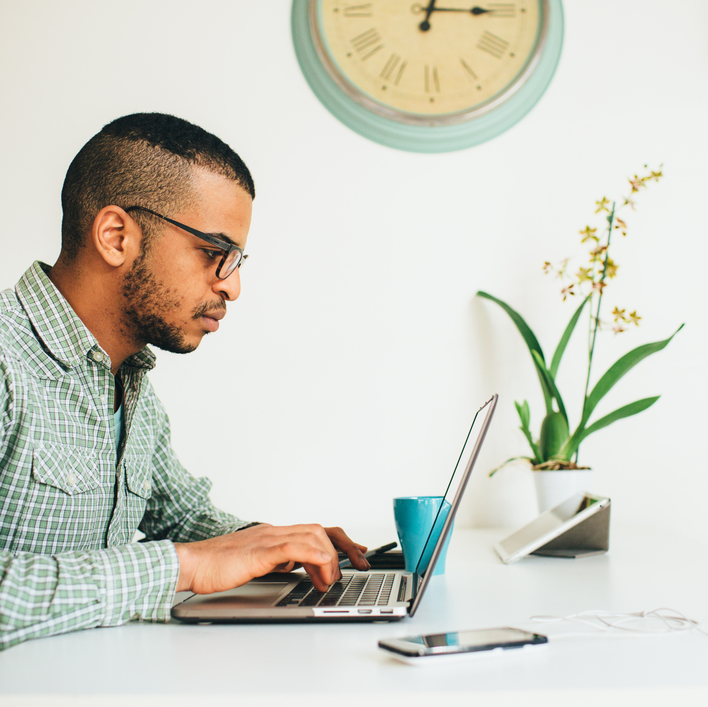 man working on laptop at desk