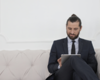 man reading about how to find a good real estate agent