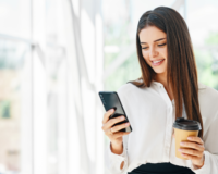 young woman smiling while using cell phone