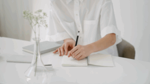 woman taking notes about how to grow a real estate brokerage